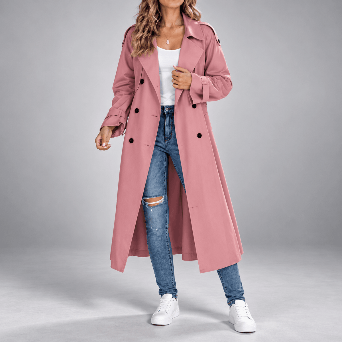 Dusty pink double-breasted longline trench coat with wide lapels, buttoned cuffs, and an oversized below-knee fit.