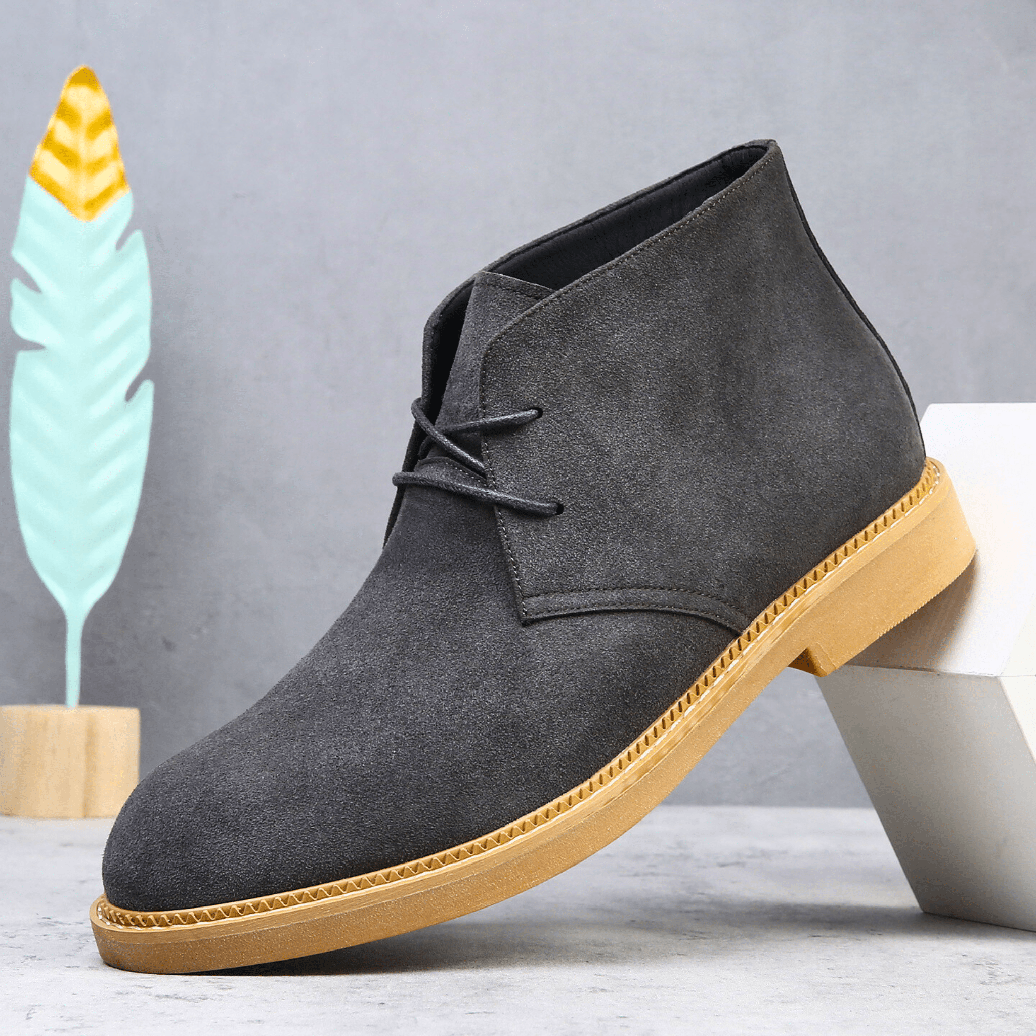 Charcoal grey suede-look desert boot with a plain toe, two-eyelet lacing, and a contrast tan welt-stitched sole.