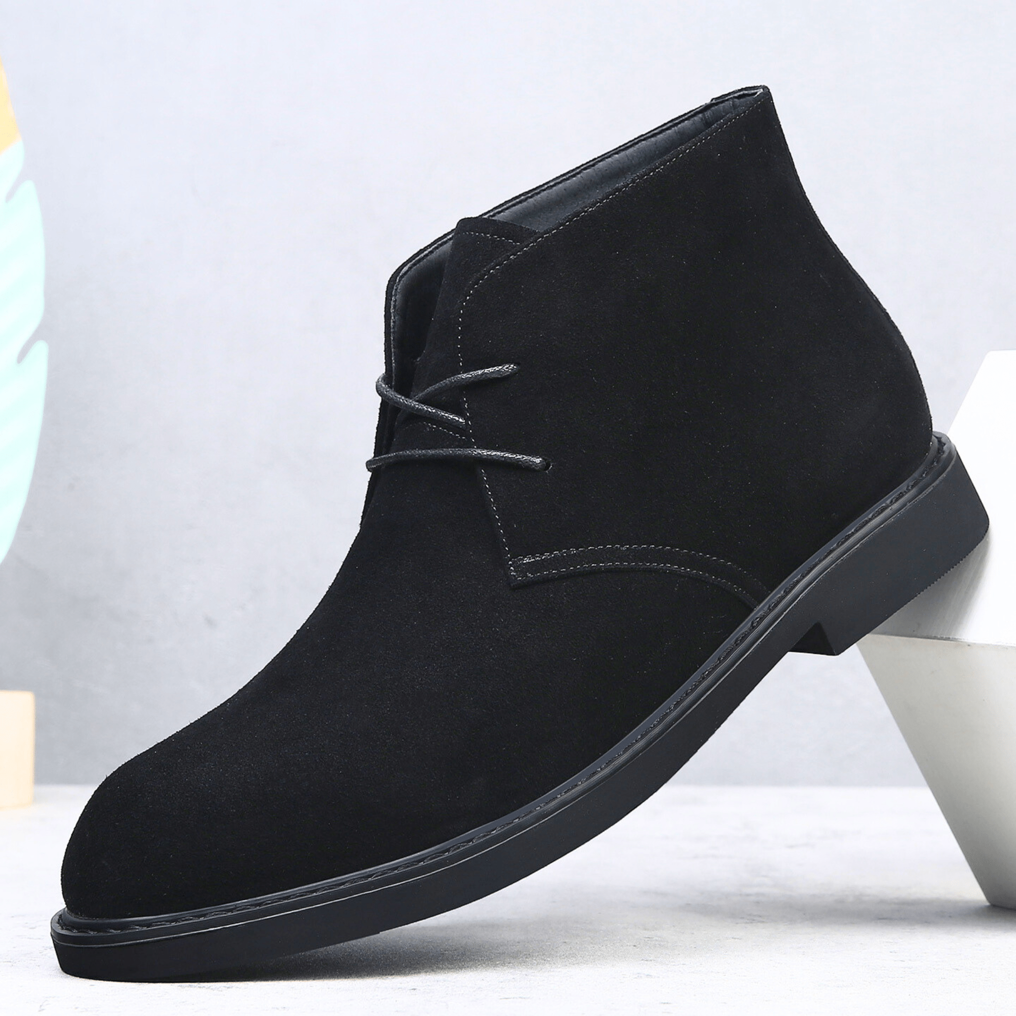 Black suede-look desert boot with a plain toe, two-eyelet lace-up closure, and a low stacked heel.