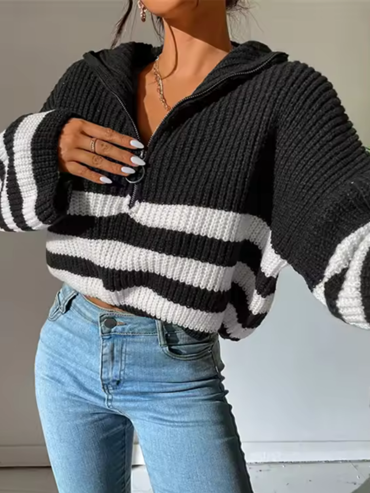Cropped black and white striped chunky ribbed knit sweater with a half-zip folded collar and flared sleeves.