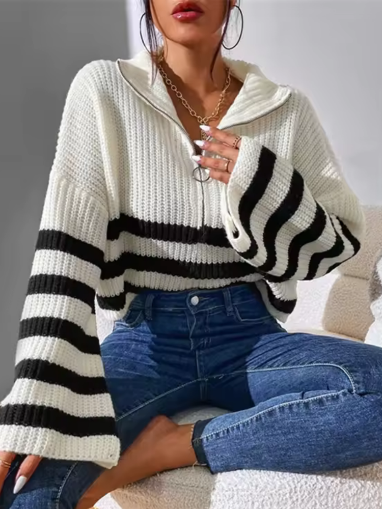 Cropped white and black striped chunky ribbed knit sweater with a half-zip folded collar and flared sleeves.