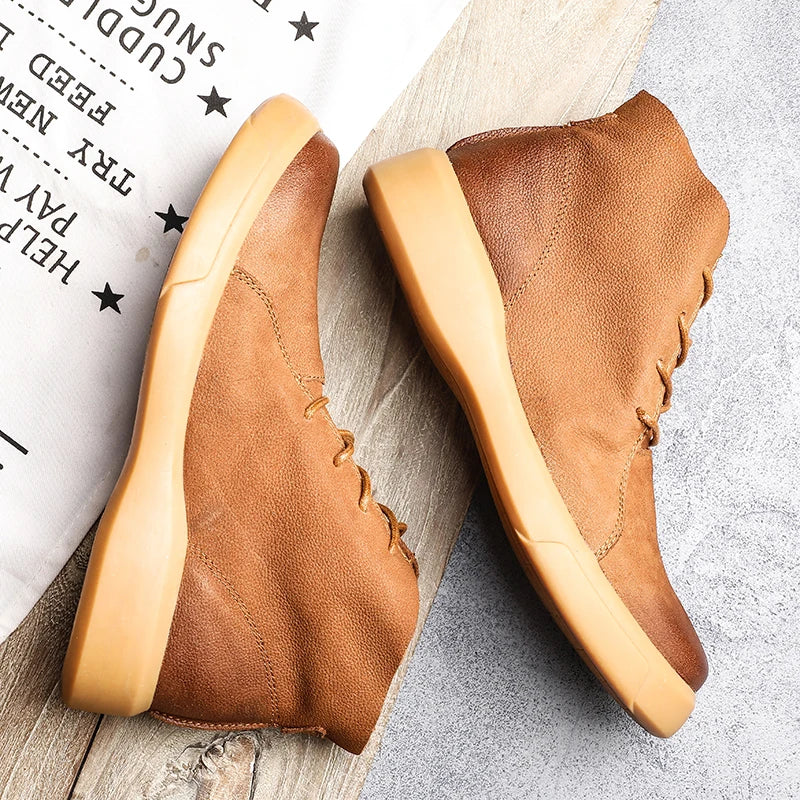 Tan leather chukka boots with a rounded toe and thick, chunky rubber sole in a lace-up ankle-height silhouette.