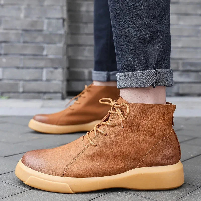 Tan leather chukka boots featuring a rounded toe, lace-up closure, and a thick, chunky rubber sole.