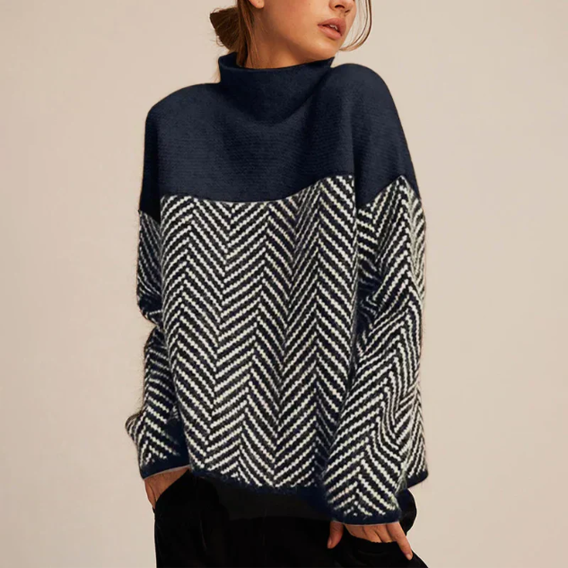 Navy and gray color-block turtleneck sweater with a herringbone knit pattern, oversized fit, and long sleeves for a cozy casual look.