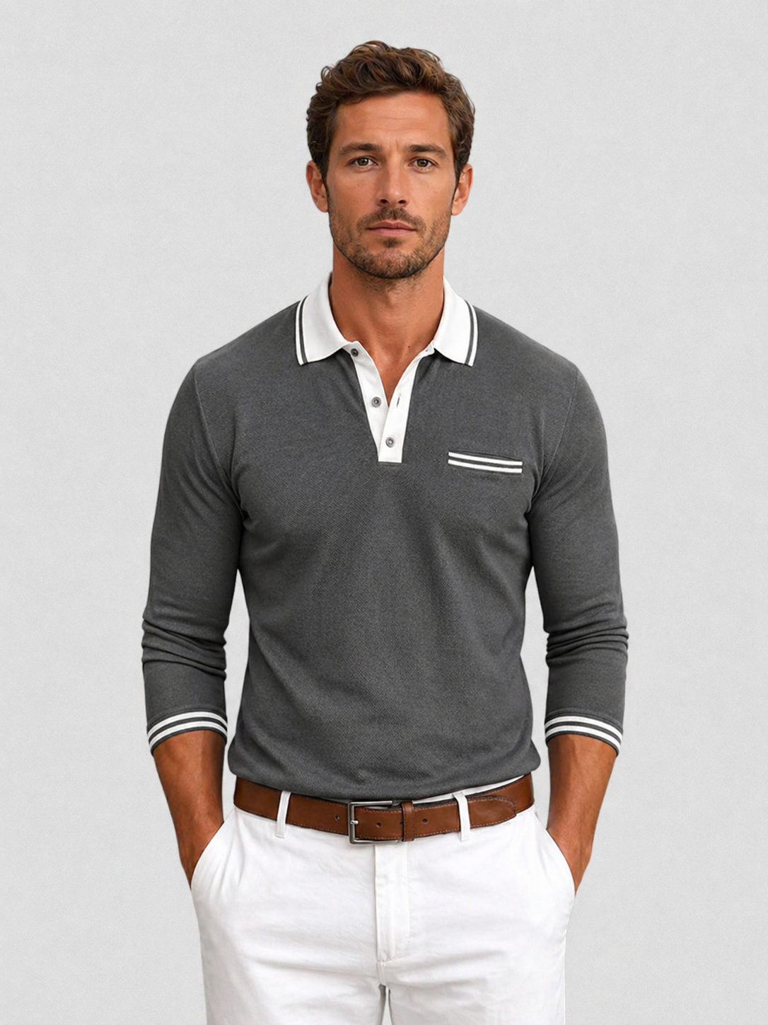 Charcoal knit long-sleeve polo with a white contrast collar, button placket, chest pocket, and striped cuff detailing.