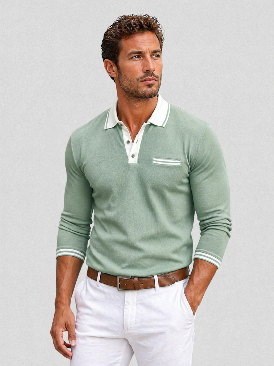 Sage green knit long-sleeve polo with a white contrast collar, button placket, chest pocket, and striped cuff detailing.
