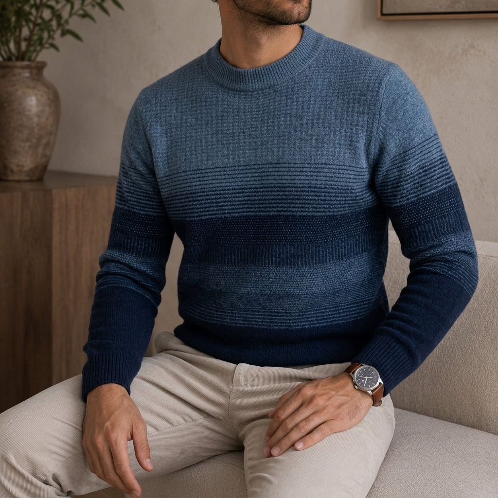 Fine wool crewneck sweater in an ombre blue-to-navy stripe pattern with a structured ribbed collar, cuffs, and hem.