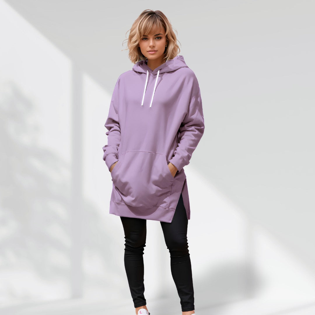 Oversized mauve brushed cotton hoodie with a longline hem, side slits, and drawstring hood worn over black leggings.