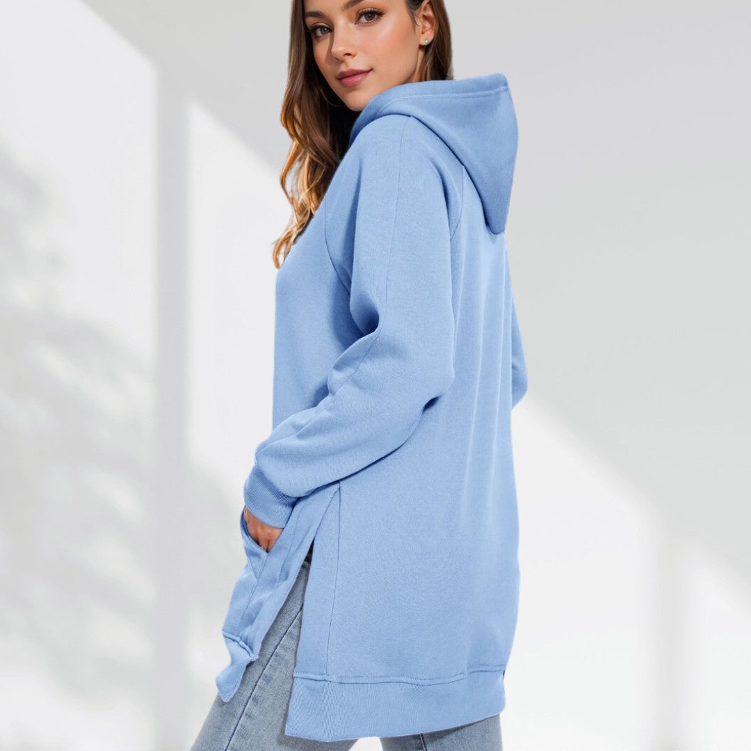 Light blue oversized brushed cotton hoodie with a longline silhouette, drawstring hood, and side-slit hem.
