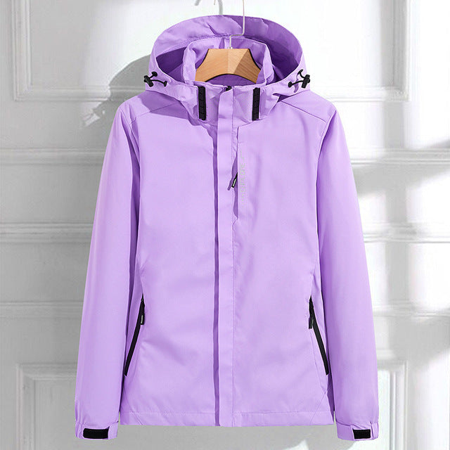 Purple hooded waterproof jacket with a full-zip closure, adjustable hood, zippered pockets, and long sleeves displayed on a white background.