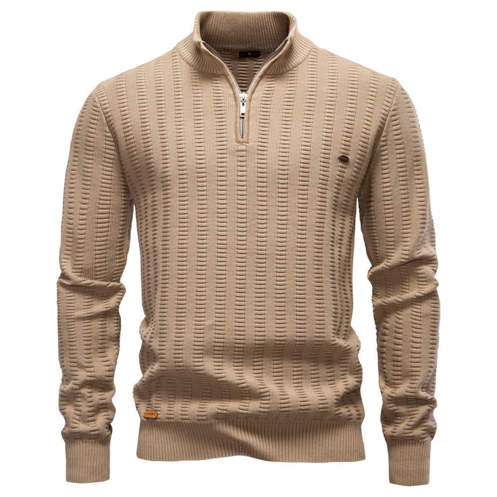 Beige textured quarter-zip knit sweater with a stand collar, ribbed cuffs, and all-over geometric knit pattern on a white background.