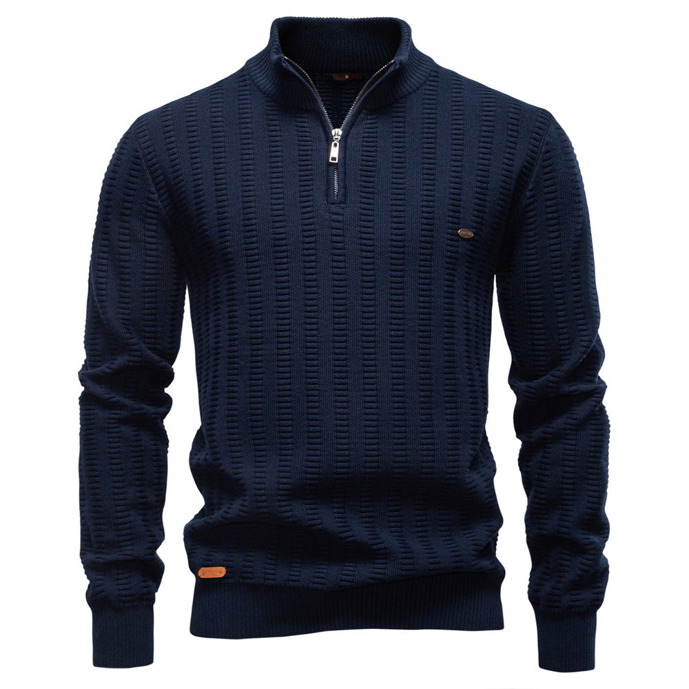 Navy textured quarter-zip knit sweater featuring a stand collar, ribbed cuffs, and all-over geometric knit pattern on a white background.