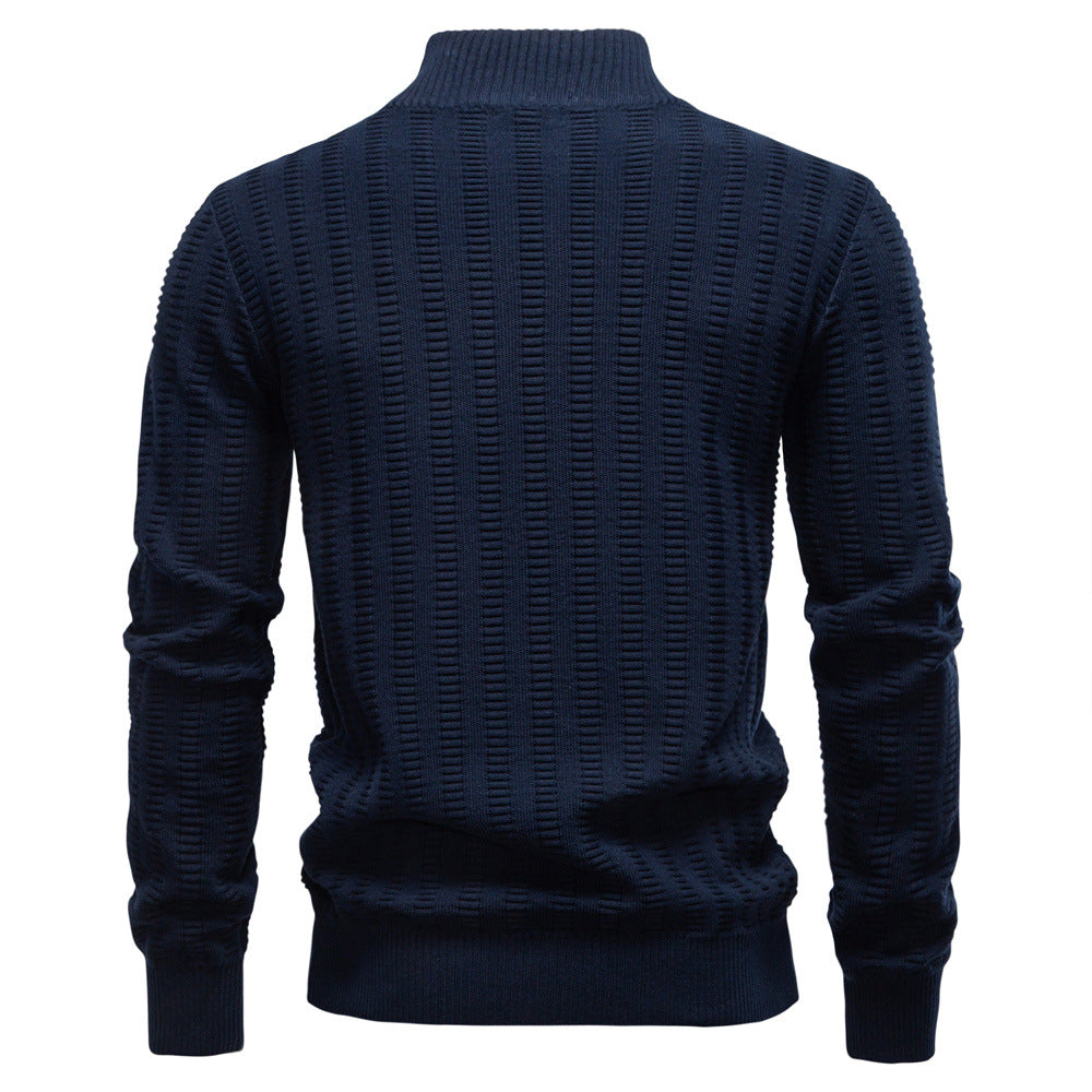 Back view of a navy textured quarter-zip knit sweater with a stand collar and geometric knit pattern on a white background.