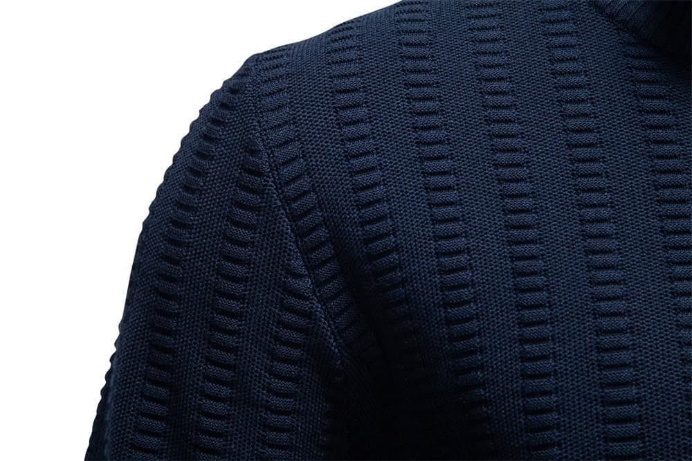 Close-up of the navy textured knit sweater shoulder showcasing the geometric knit pattern and premium fabric texture.