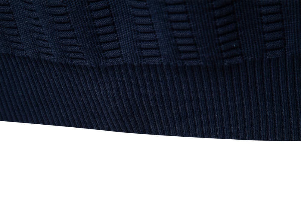 Close-up of the navy knit sweater ribbed hem highlighting the fine textured knit finish.