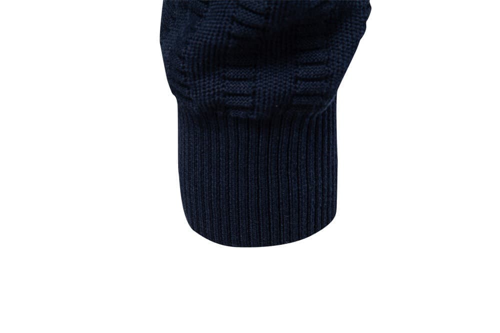 Close-up of the navy sweater ribbed sleeve cuff with textured knit construction.