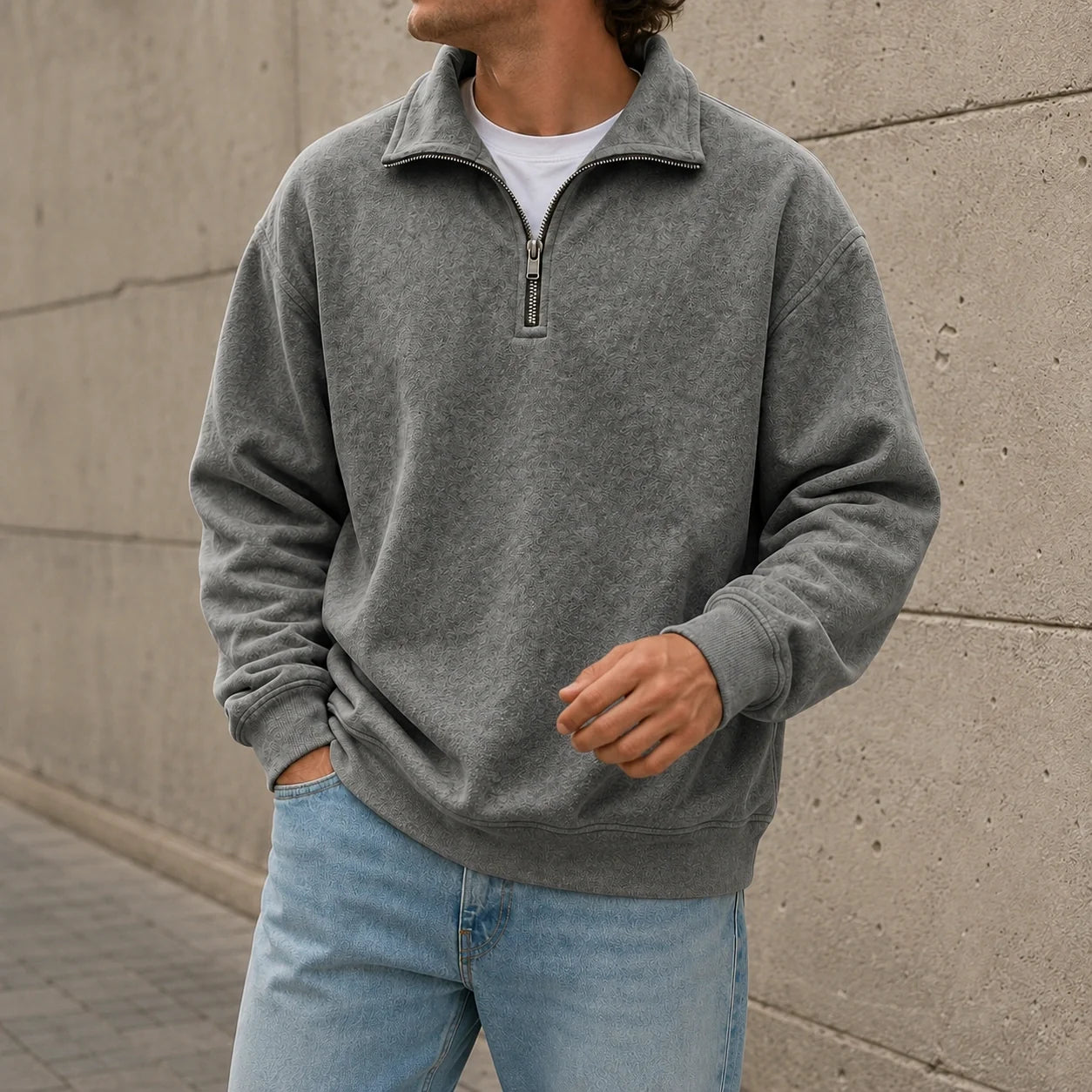 Gray quarter-zip fleece sweatshirt featuring a stand collar and relaxed fit, styled with light blue jeans outdoors.