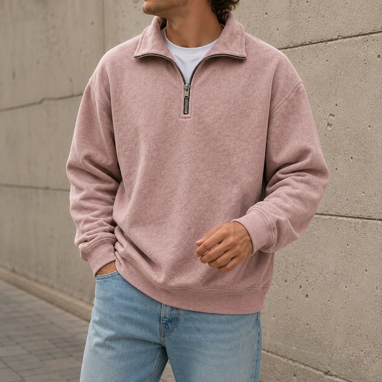 Dusty pink quarter-zip fleece sweatshirt with a stand collar and relaxed fit, worn with light blue jeans.