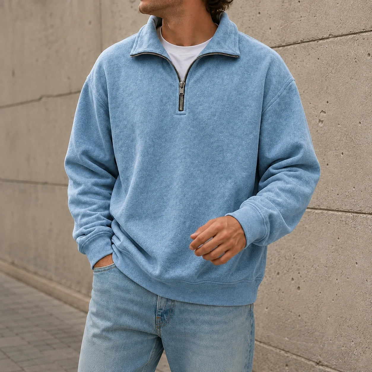 Light blue quarter-zip fleece sweatshirt featuring a stand collar and relaxed fit, paired with light blue jeans.