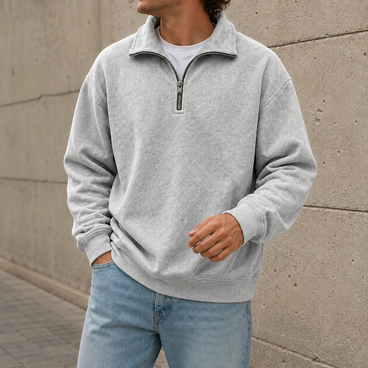 Light gray quarter-zip fleece sweatshirt featuring a stand collar and relaxed fit, worn with light blue jeans.
