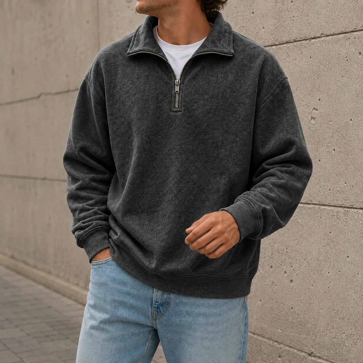 Charcoal quarter-zip fleece sweatshirt with a stand collar and relaxed fit, paired with light blue jeans.