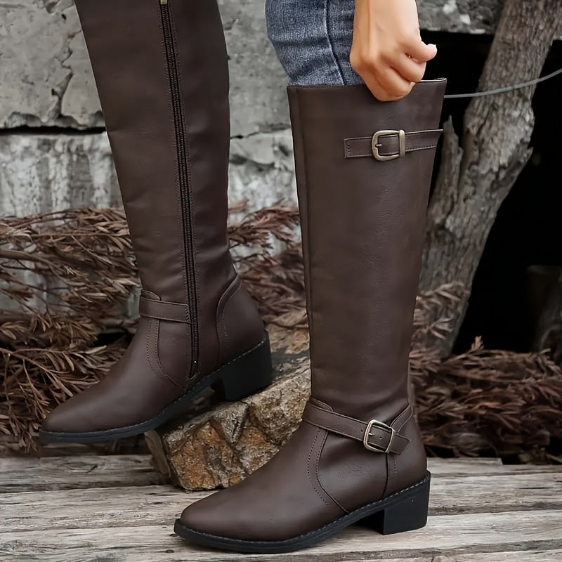 Dark brown knee-high boots with structured shafts, antique buckle straps, and stacked block heels featuring full-length inside zips.