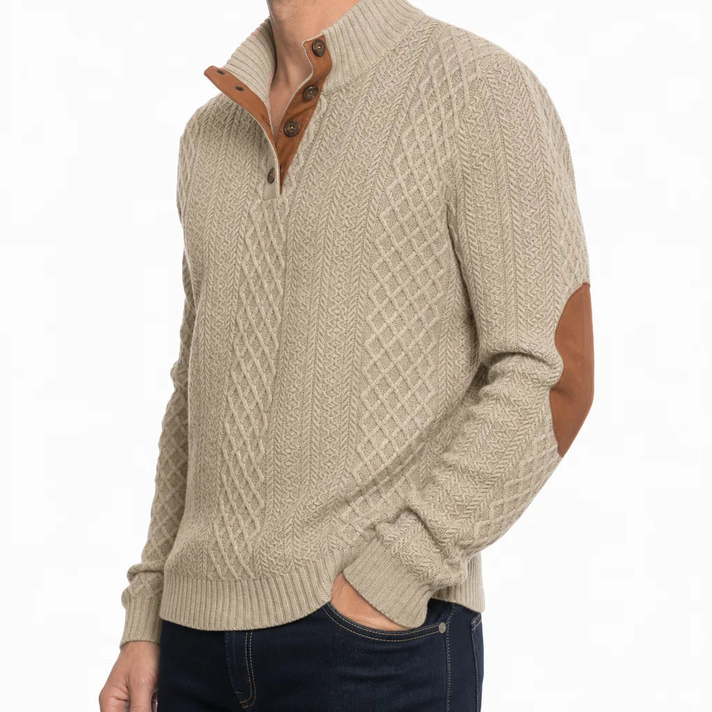 Beige cable-knit henley sweater featuring a mock neck button placket and contrast brown elbow patches.