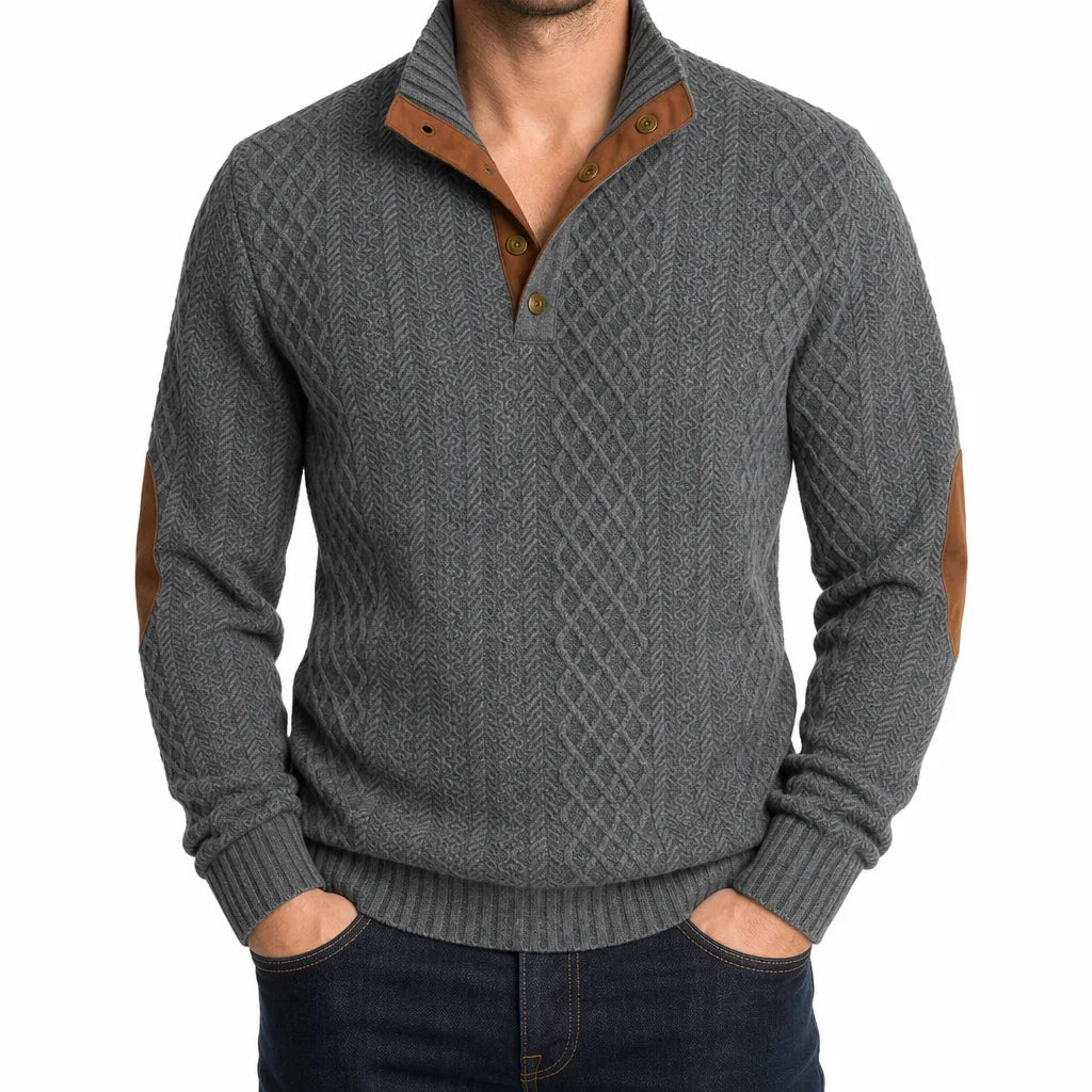 Grey cable-knit henley sweater featuring a mock neck button placket and contrast brown elbow patches.
