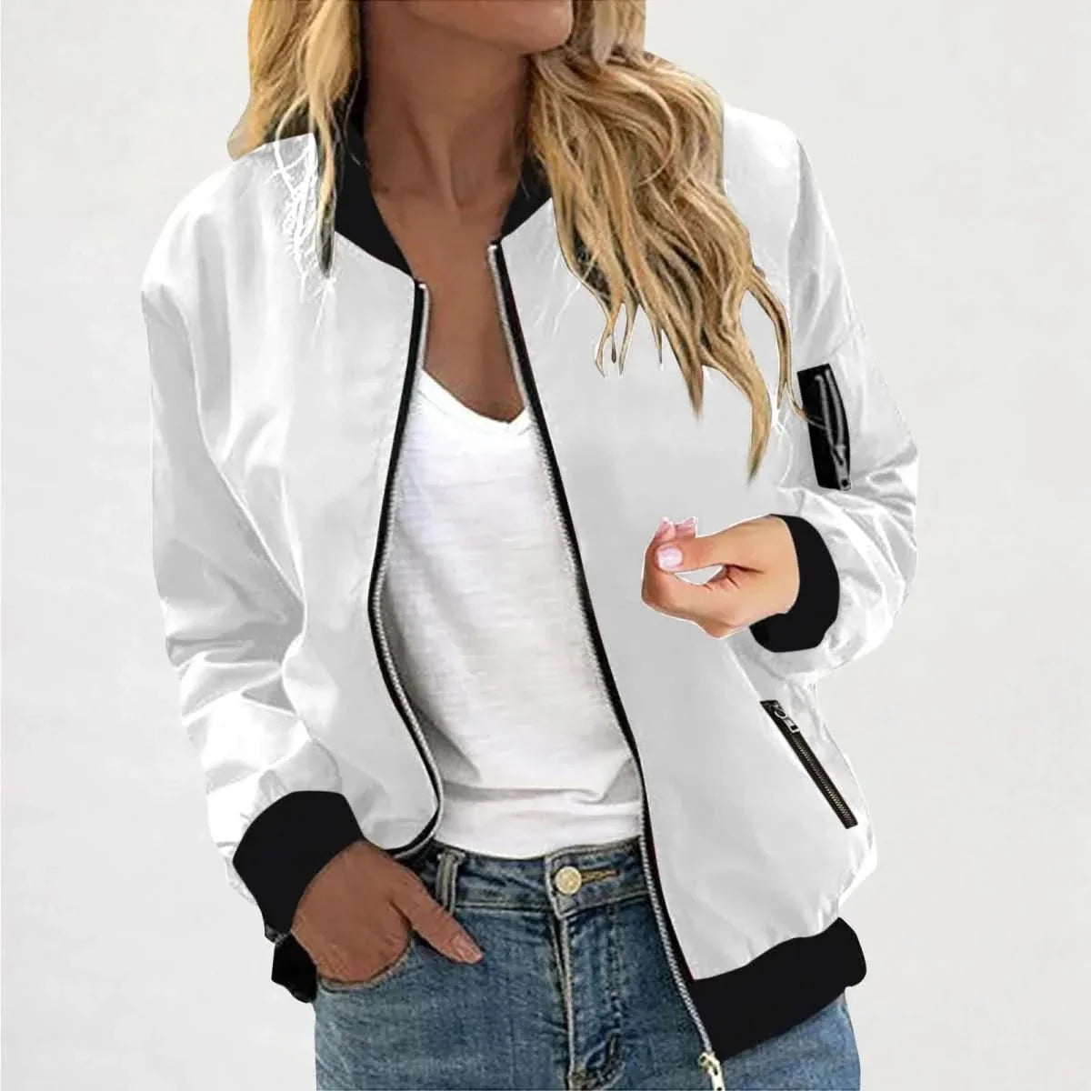 Woman wearing a white bomber jacket featuring a full-zip closure, black ribbed trim, and a casual fit.