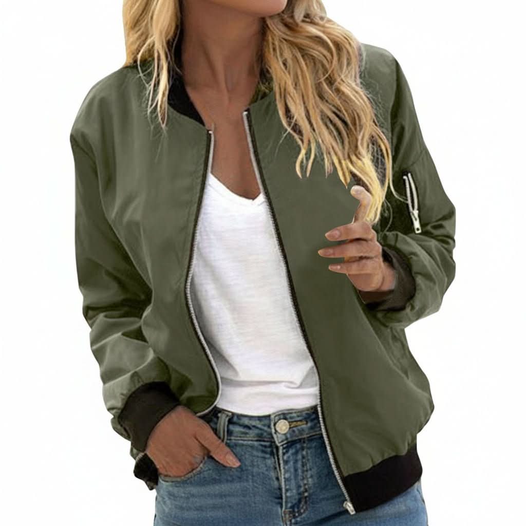 Woman wearing an olive green bomber jacket with a zip-front closure, ribbed cuffs, and ribbed hem paired with blue jeans.