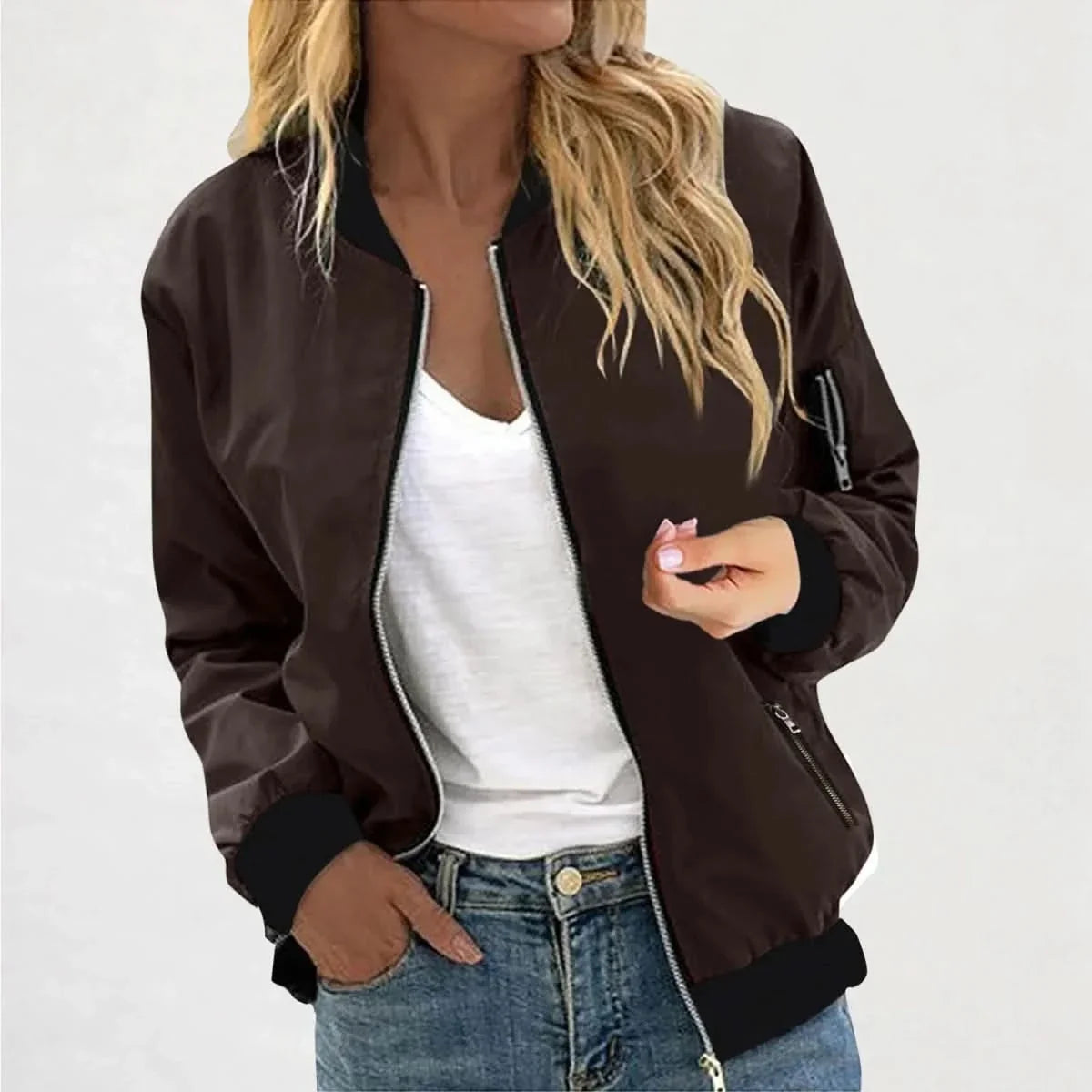 Woman wearing a dark brown bomber jacket with a full-zip front, ribbed cuffs, and a relaxed silhouette.