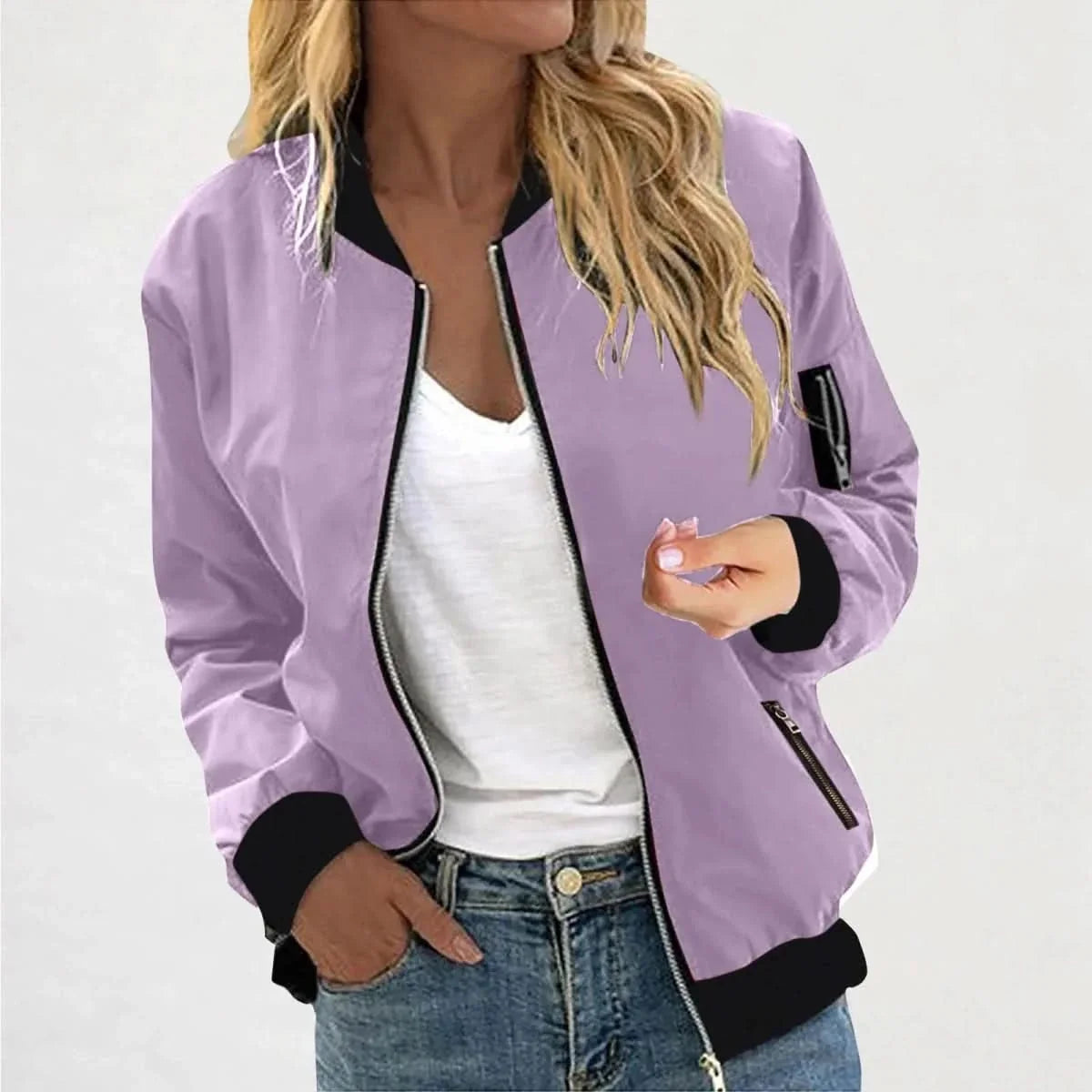 Woman wearing a purple bomber jacket featuring a zip-front closure, ribbed cuffs, and a lightweight design.
