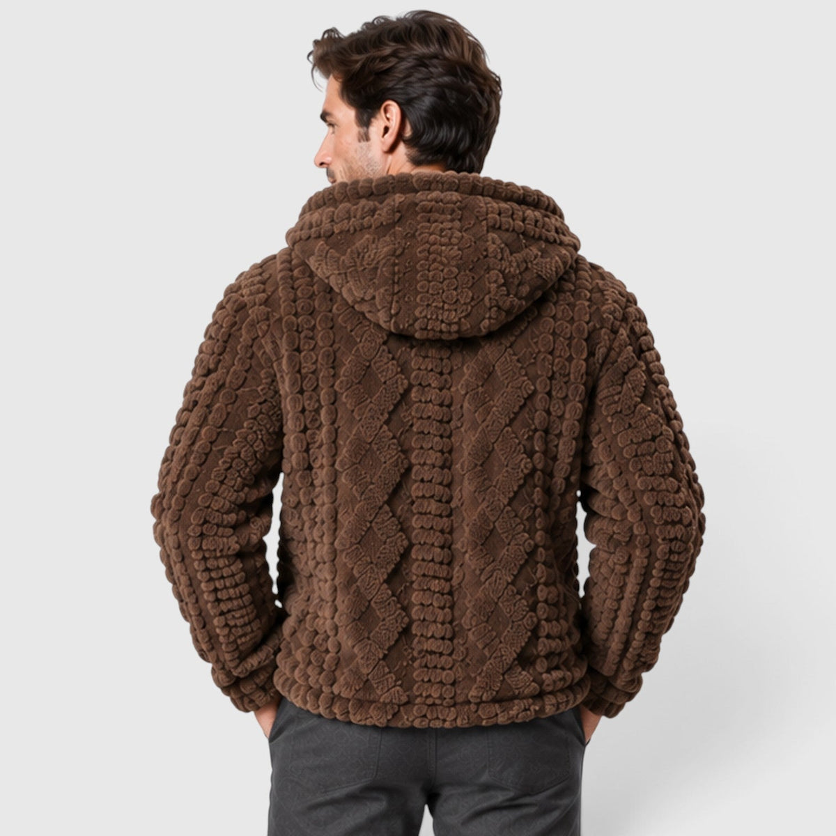 Back view of a man wearing a dark brown hooded fleece jacket showing the cable-knit texture pattern across the back and hood.