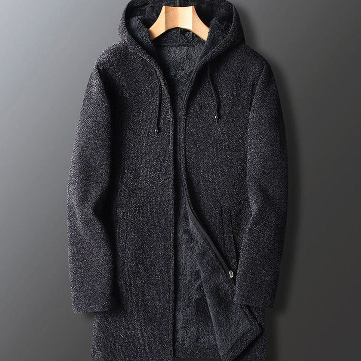 A men's dark charcoal dark gray longline hooded zip-up coat with a textured knit finish and soft interior lining.