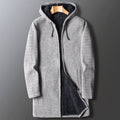 A men's light gray longline hooded coat with a textured knit outer shell, dark plush sherpa lining, drawstring hood, and front zipper, displayed hanging against a neutral background.