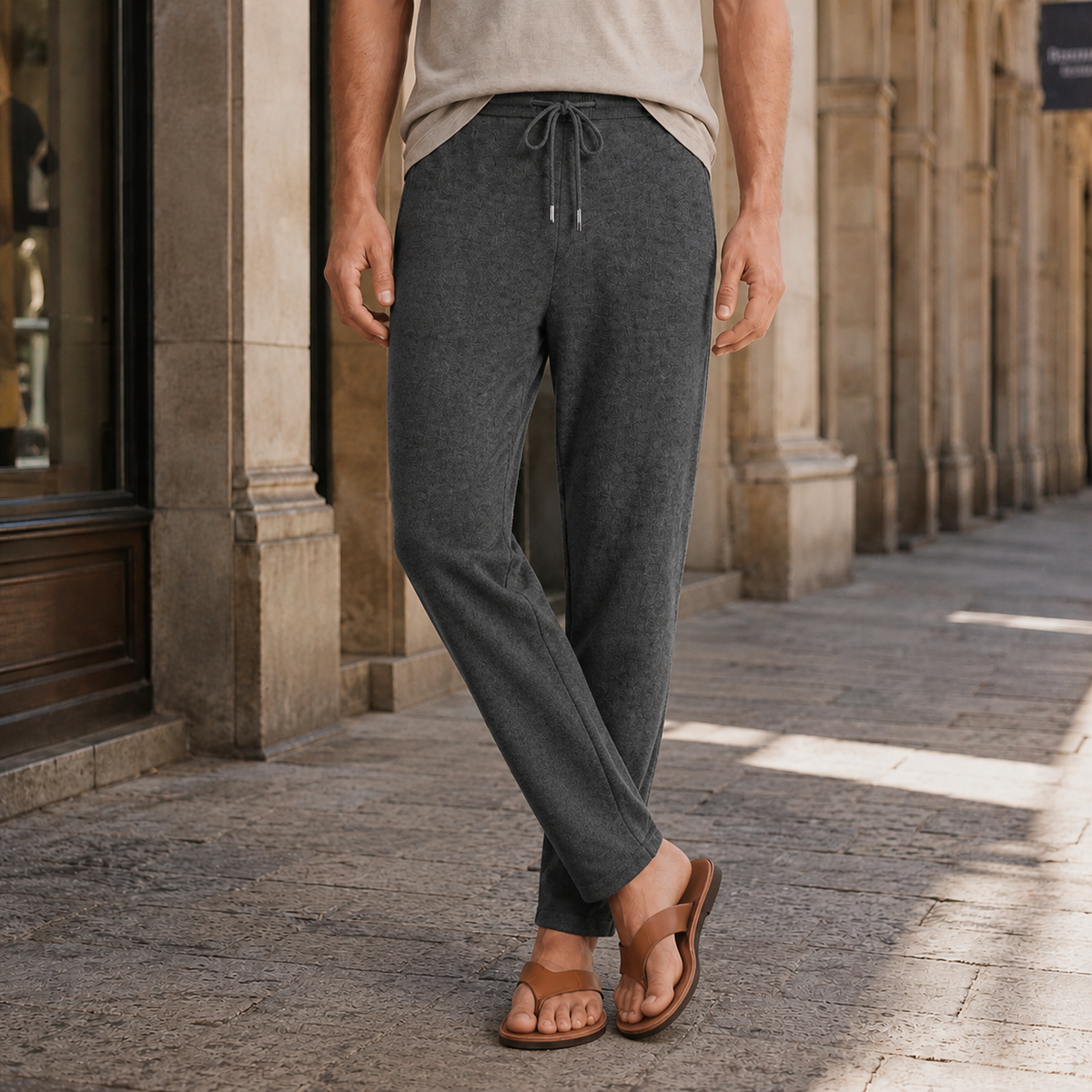 Charcoal gray merino wool pants featuring a relaxed tapered fit, elastic drawstring waist, and fine-knit texture.