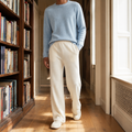 Ivory-colored merino wool pants in a relaxed wide-leg fit with a high-rise elastic waist and side pockets.