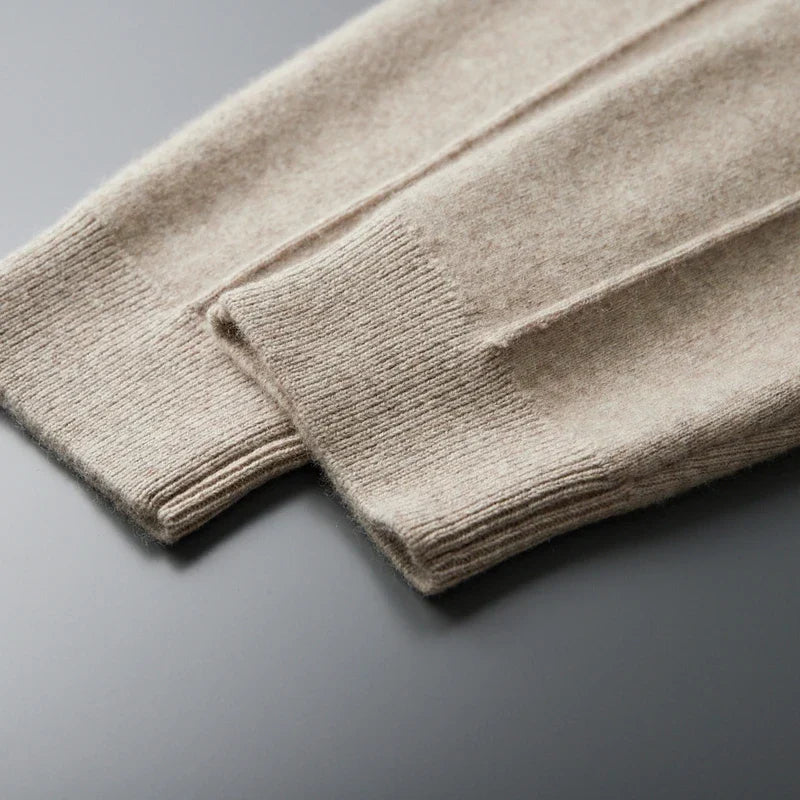 Beige merino wool trousers featuring a soft, fine-knit texture and ribbed tapered ankle cuffs.