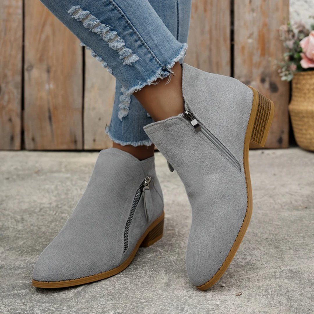Grey brushed suede low-cut booties with an angled side zip, almond toe, and a low stacked block heel.