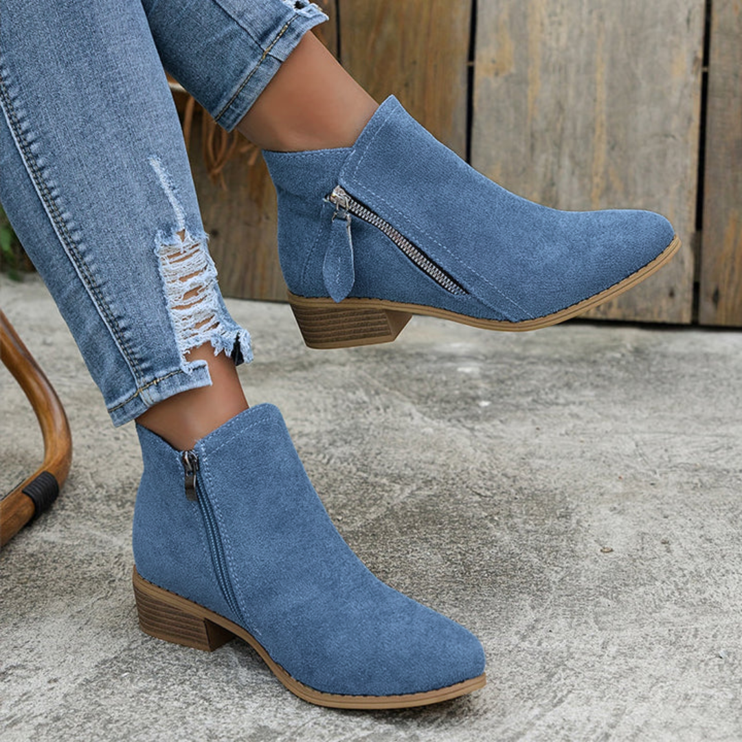Blue brushed-finish low-cut booties with an almond toe, angled side zipper, and a stacked block heel.