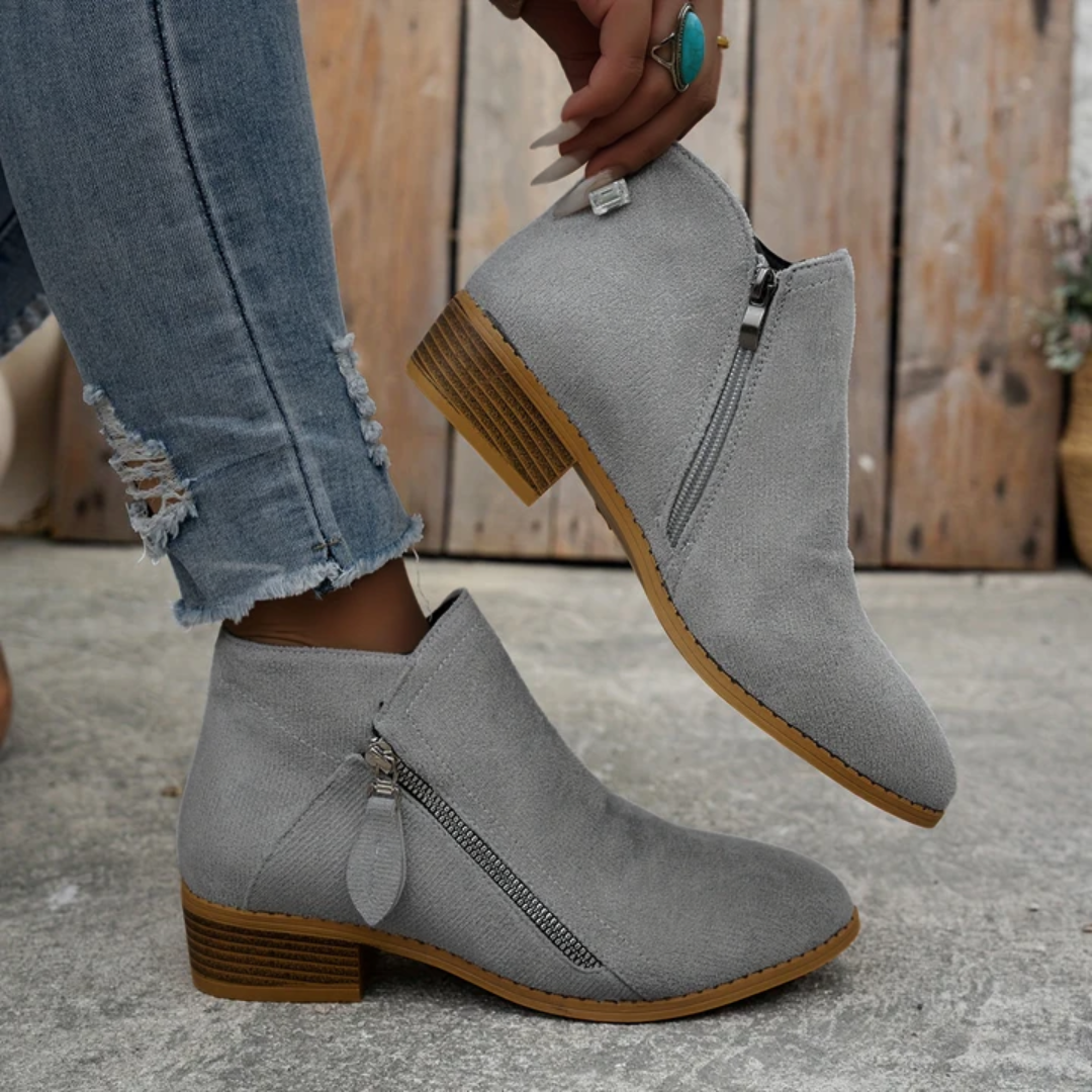 Grey brushed-finish low-cut booties with an angled side zipper, almond toe, and a stacked wooden block heel.