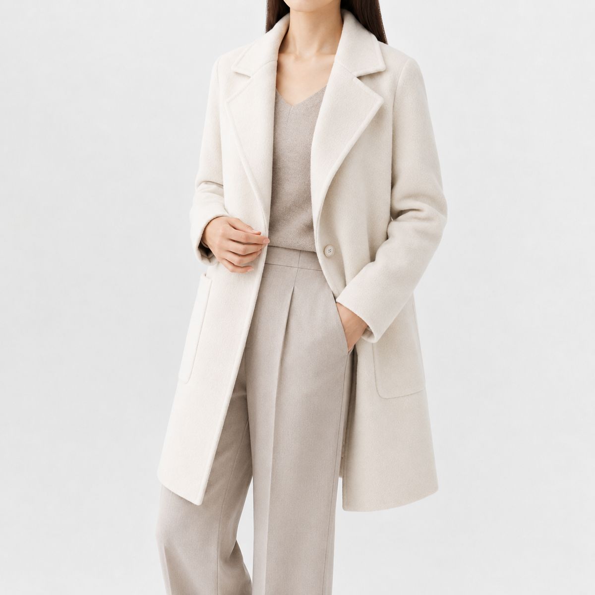 Cream mid-length wool coat with a notch lapel, single-button front, and square patch pockets in a soft-touch finish.