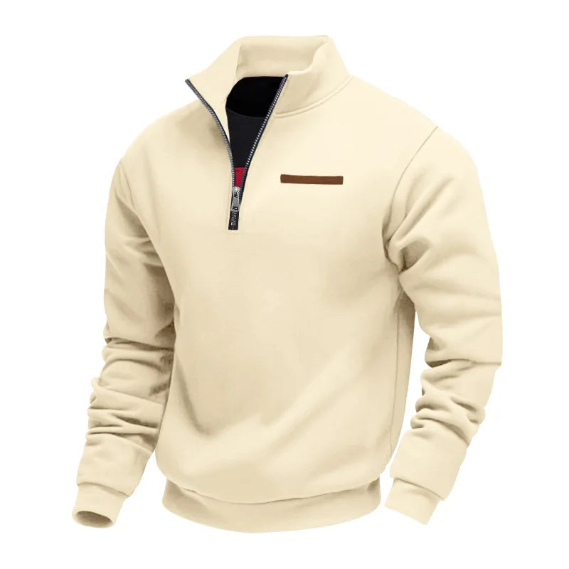 Beige half-zip fleece sweatshirt featuring a stand collar, ribbed cuffs, and chest accent detail on a white background.