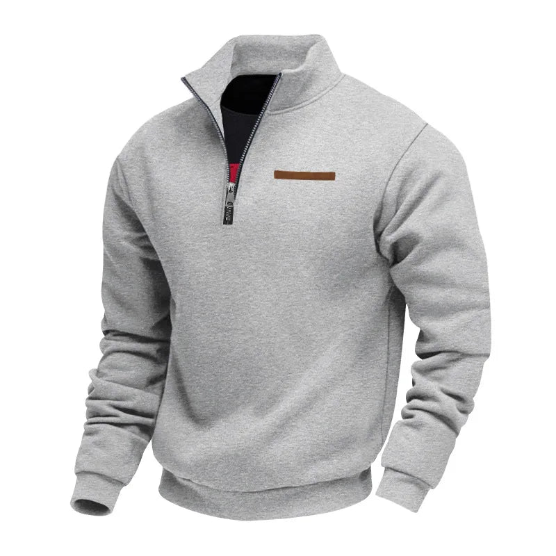 Light gray half-zip fleece sweatshirt with a stand collar, ribbed cuffs, and chest accent detail shown from an alternate angle on a white background.