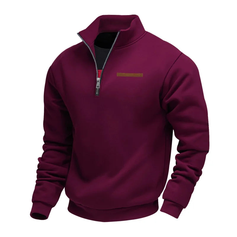 Burgundy half-zip fleece sweatshirt featuring a stand collar, ribbed cuffs, and chest accent detail on a white background.