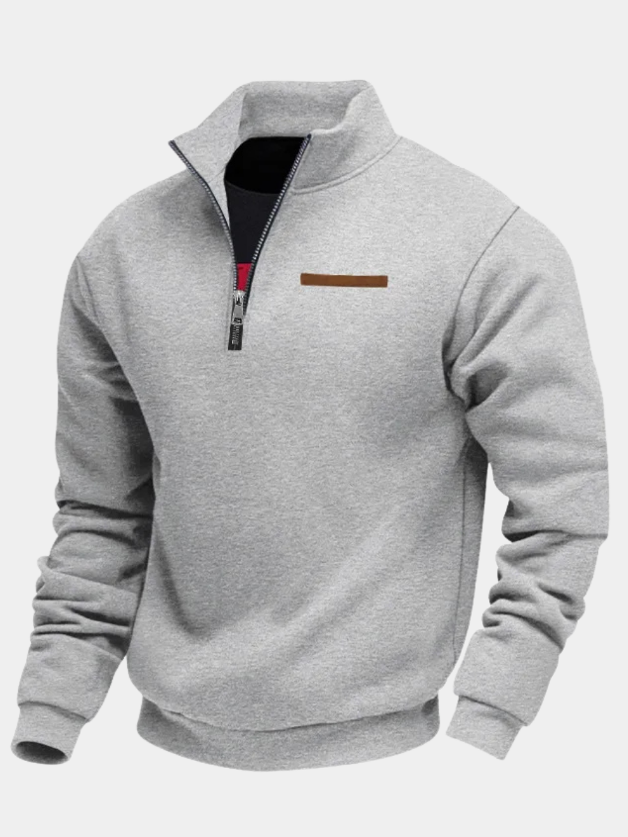 Light gray half-zip fleece sweatshirt with a stand collar, ribbed cuffs, and chest accent detail on a white background.
