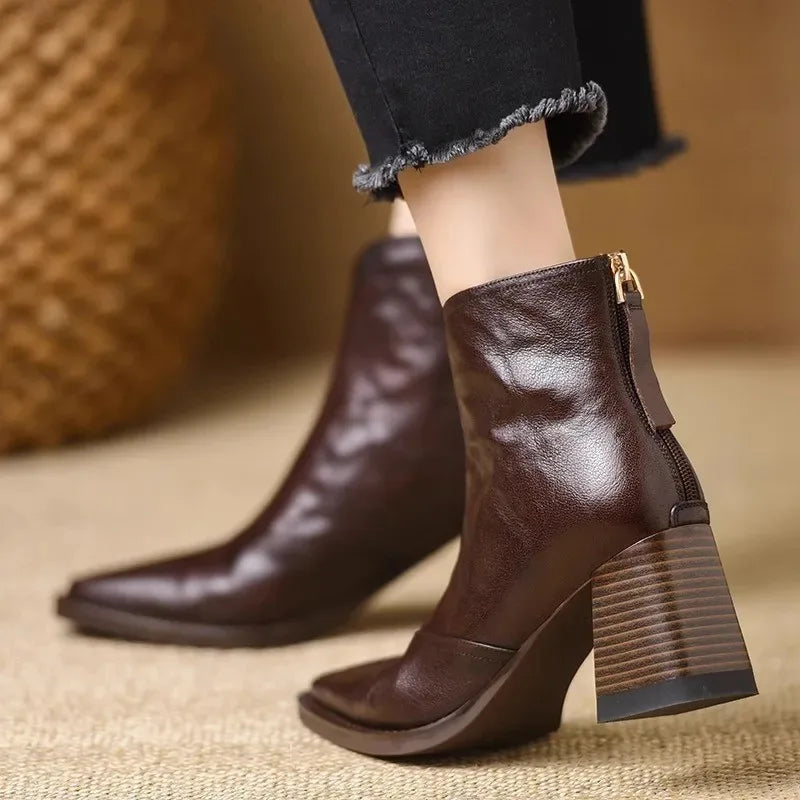 Dark brown square-toe ankle boots with a notched front, back zip closure, and a stacked block heel.