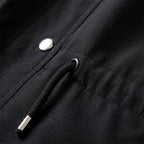 Black cotton blend utility jacket featuring a drawstring waist, silver hardware, and durable fabric texture.