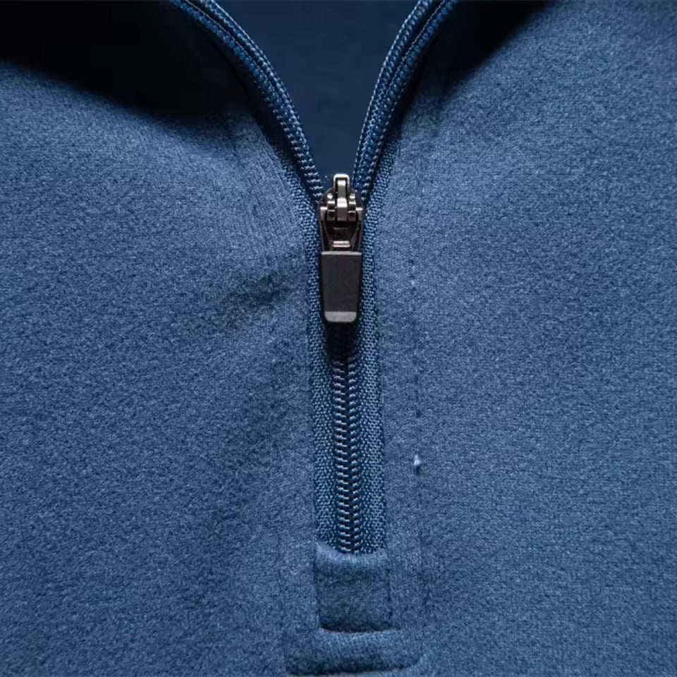 Blue brushed quarter-zip sweater with a matte, napped finish and a tonal zipper detail on a structured funnel collar.