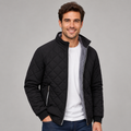 Black diamond-quilted zip-up jacket with a ribbed stand collar, plush grey lining, and relaxed fit worn over a white tee.